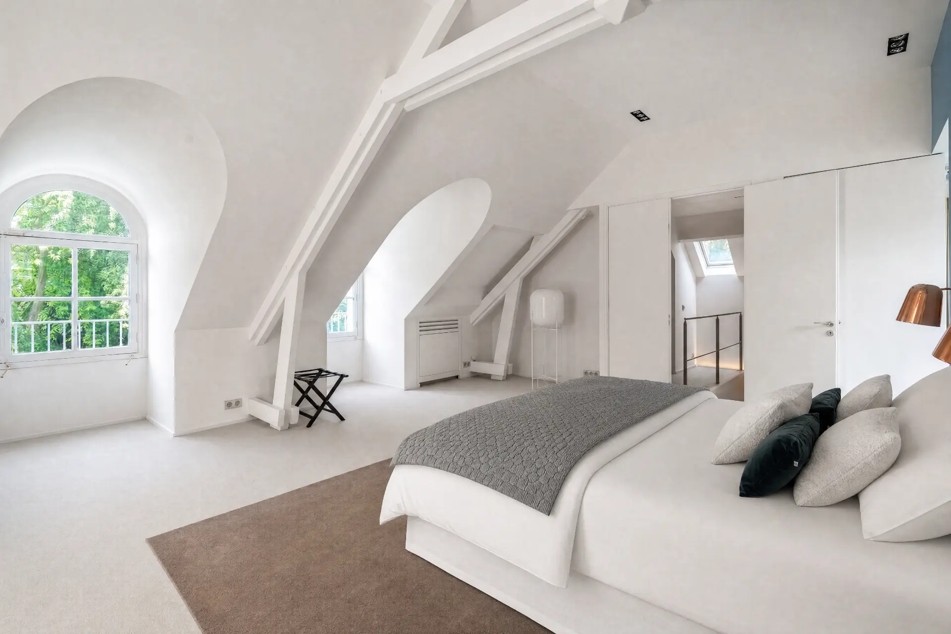 The attic floor, open beneath the beams
