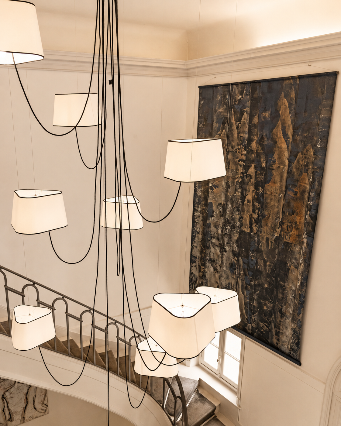 A cascade of pendant shades above the stairwell