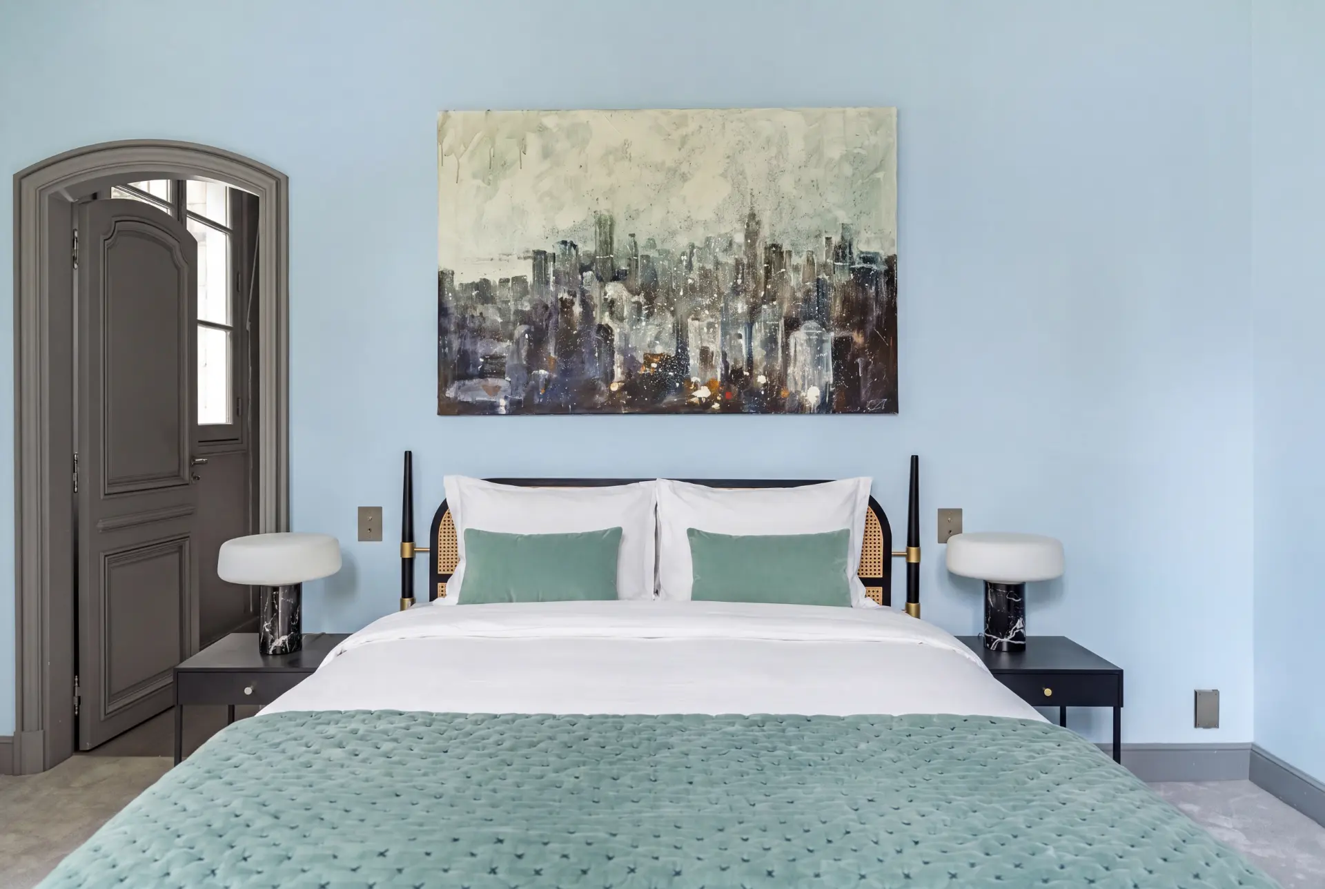 Bedroom in pale blue with a contemporary canvas